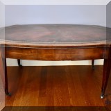 F38. Leather topped vintage coffee table. 17” x 42” x 22”w 